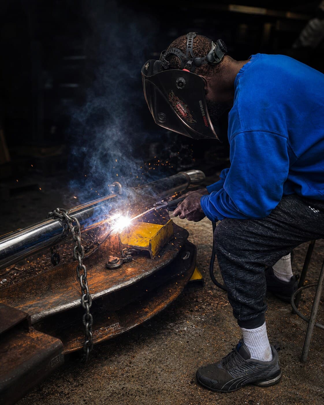 Master craftsman welding metalwork at Southern Machinist Company